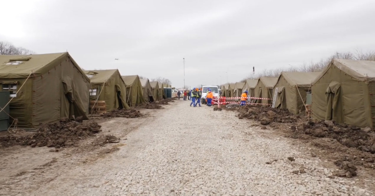 Tents on the left and right of a street within the courtyard of the ROL2 Military Campaign Hospital